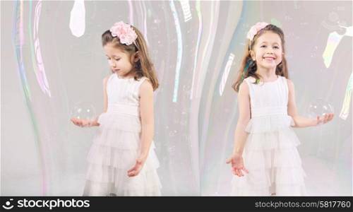 Little girls closed in large soap bubbles