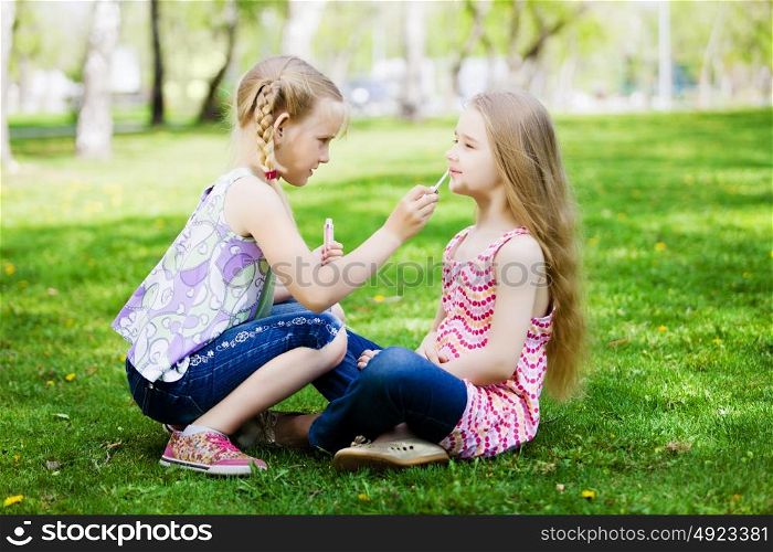 Little girls in park. Image of two little cute girl playing on grass in park