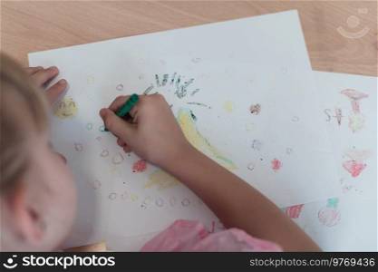 Little girls sitting in elementary school drawing on paper. High quality photo. Little girls sitting in elementary school drawing on paper 