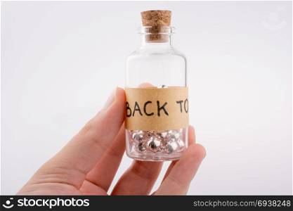 Little glass bottle in hand on a white background