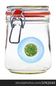 little green rural planet preserved in closed glass jar