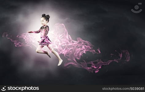 Little gymnast. Cute girl gymnast in performance costume jumping high