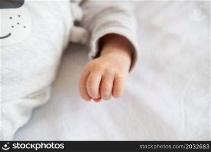 Little hands of a newborn baby, holding a fist, little fingers. The first month of a baby&rsquo;s life. Little hands of a newborn baby, holding a fist, little fingers. The first month of a baby&rsquo;s life.