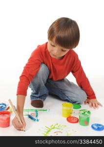 little happy boy draws paint. Isolated on white background