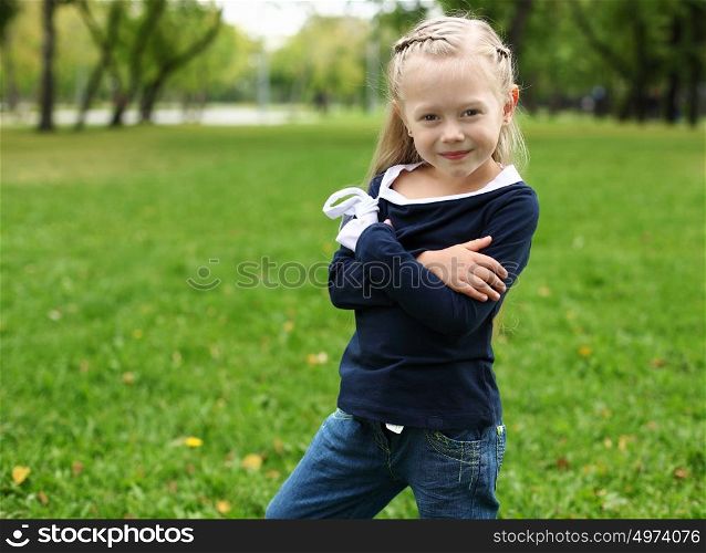 little happy girl in green summer park