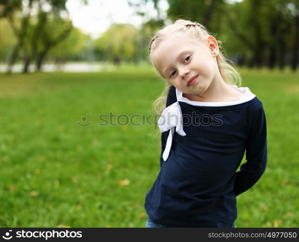 little happy girl in green summer park