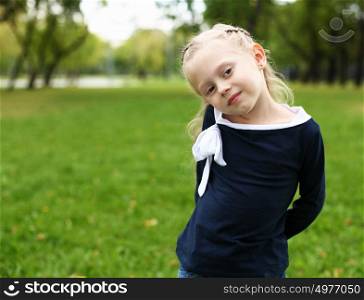 little happy girl in green summer park