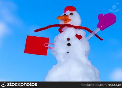 Little happy valentine snowman in red scarf and with clip paper card text message heart outdoor. Winter season seasonal specific valentine&#39;s day. Blue sky background.