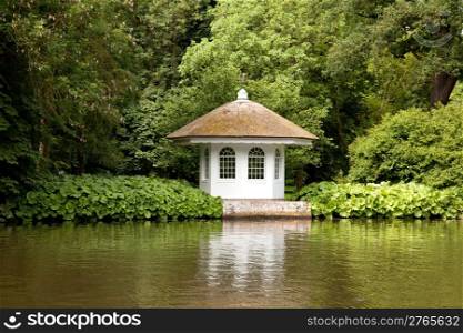 little house in rich garden on the embankment of the river Vecht in Holland