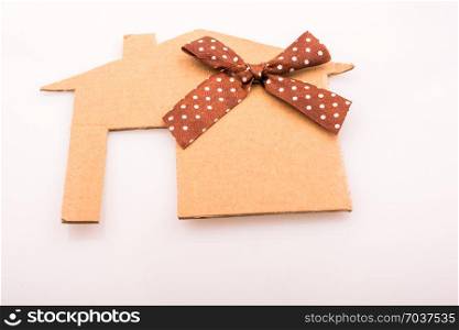 Little house shape cut out of paper with ribbon