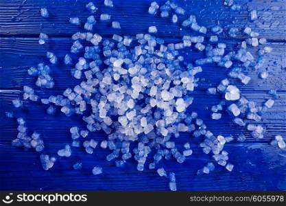 little ice cubes over blue wood background