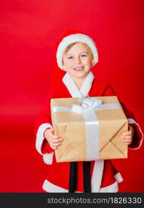 Little kid boy dressed as Santa Claus. Christmas shopping. Christmas present. Childhood. New Year party. Santa Claus baby. Happy winter holidays.. Little kid boy dressed as Santa Claus. Christmas shopping. Christmas present. Childhood. New Year party. Santa Claus baby.