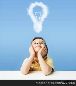 Little kid dreaming about a light bulb