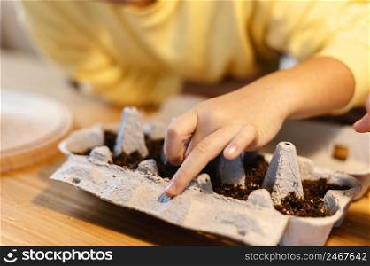 little kid planting seeds home