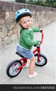 Little kid riding his bike down the street