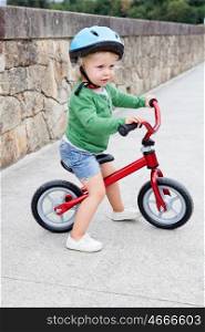 Little kid riding his bike down the streetl