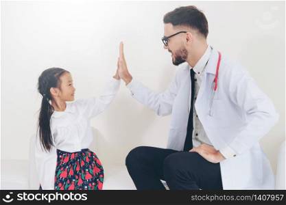 Little kid visit doctor in hospital office. The kid is happy and not afraid of the doctor. Medical and children healthcare concept.. Happy little kid visit doctor in hospital office.