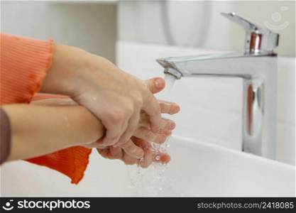 little kids washing their hands close up