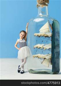 Little lady next to a ship in a bottle