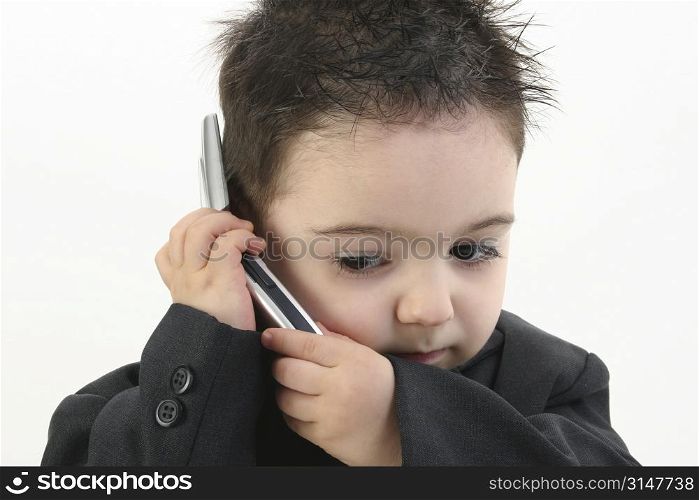 Little man discussing important business on the cell phone.