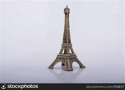 Little model Eiffel Tower on a white background