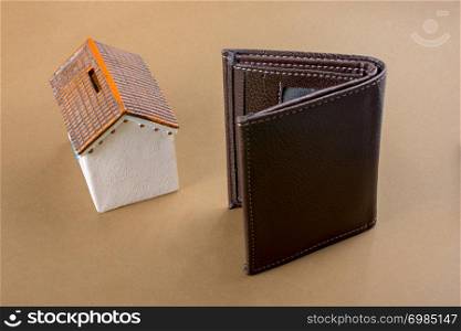 Little model house beside a wallet in view
