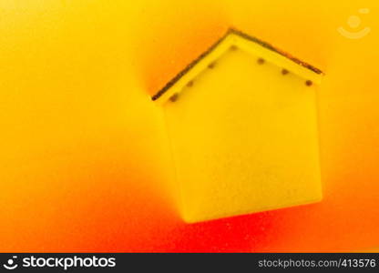 Little model house on a color background in the view