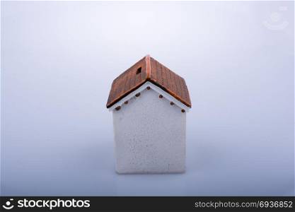 Little model house on a light brown color background