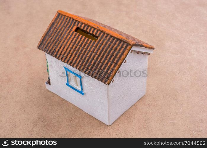 Little model house placed on a brown background
