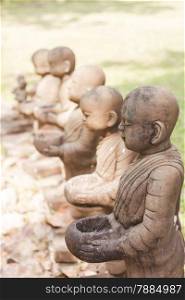 Little monk clay doll decorated in garden, stock photo
