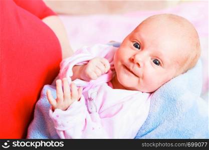 Little newborn smiling baby in pyjamas lying on back. Face expression. Family, parenthood, childhood concept.. Family, childhood concept. Little newborn baby
