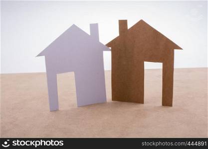 Little paper houses on a brown background