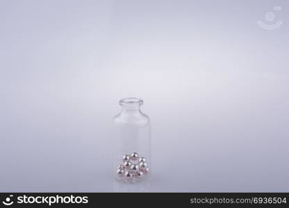 Little perfume glass bottle in hand on a white background