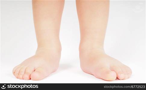 Little person standing up barefoot towards bright background