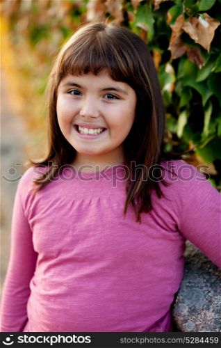 Little preteen girl with pink t-shirt in park