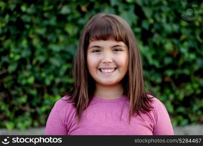Little preteen girl with pink t-shirt in park