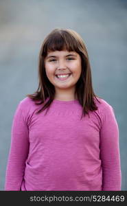 Little preteen girl with pink t-shirt in park