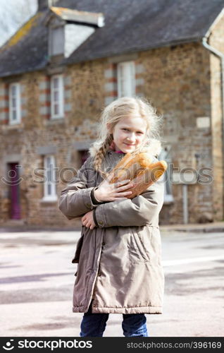 little pretty french girl with baguettes on the street side of the city