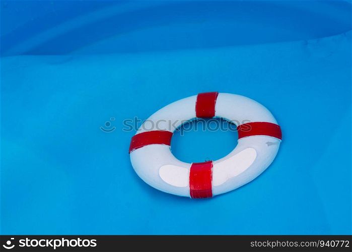 Little red and white color model life buoy in water