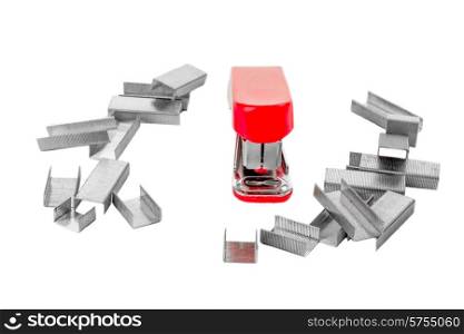 Little red stapler on white isolated background, facing the viewer, and surrounded by staples.