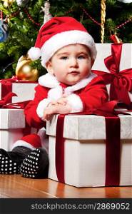 Little Santa boy with gift boxes.