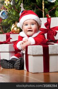 Little Santa boy with gift boxes.