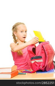 Little schoolgirl packing her rucksack