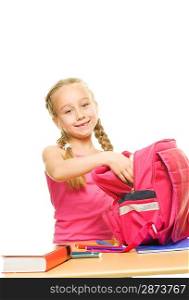 Little schoolgirl packing her rucksack