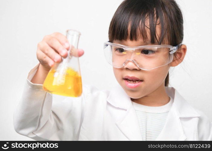 Little scientist. Smiling little girl learning classroom in school lab holding test tubes Little girl playing science experiment for home schooling.