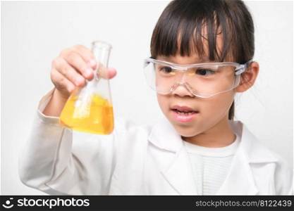 Little scientist. Smiling little girl learning classroom in school lab holding test tubes Little girl playing science experiment for home schooling.