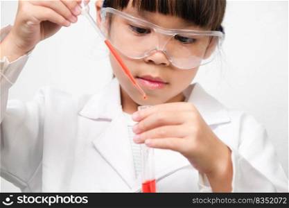 Little scientist. Smiling little girl learning classroom in school lab holding test tubes. Little girl playing science experiment for home schooling.