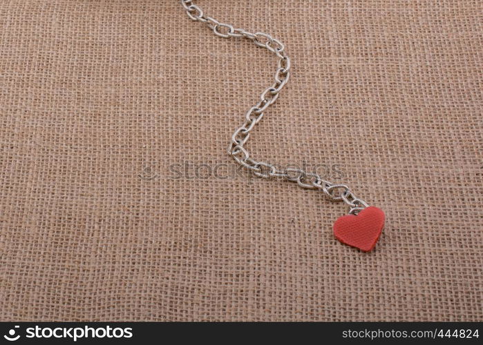 Little sized books attached to a heart with a chain