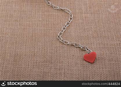 Little sized books attached to a heart with a chain