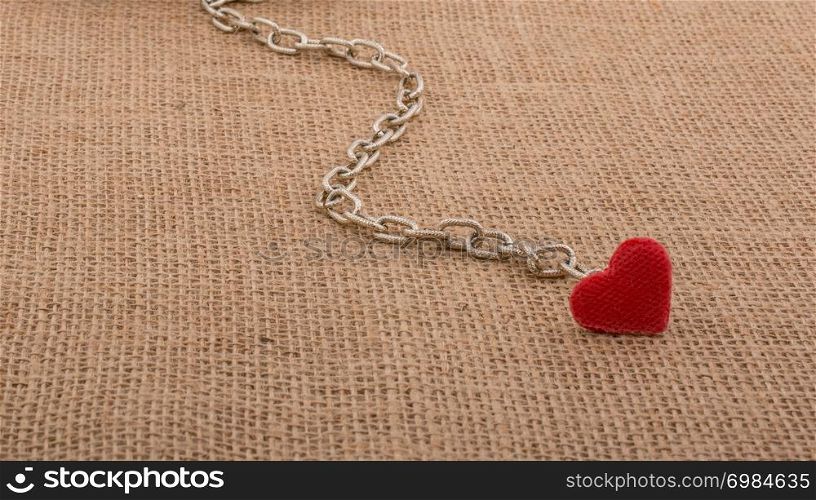 Little sized books attached to a heart with a chain